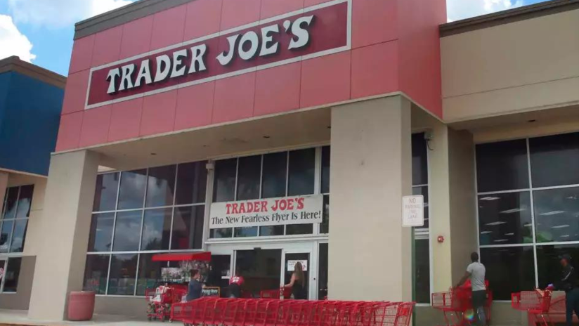 People stand in line waiting to enter Trader Joe's to buy groceries in Pembroke Pines, Fla., on March 24, 2020. More than 61,000 pounds of steamed chicken soup dumplings sold at Trader Joe's are being recalled for possibly containing hard plastic, U.S. regulators announced Saturday, March 2, 2024.